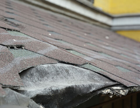 Roof with weather damage from a storm