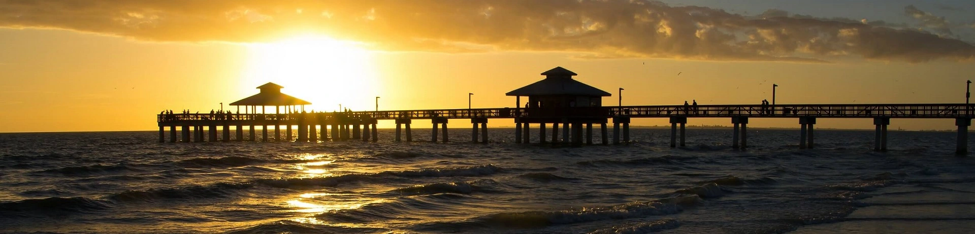 sunset behind public pier in lee county