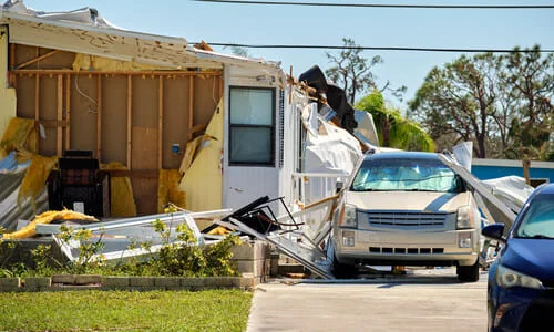 A garage and vehicles damaged in the aftermath of Hurricane Ian.