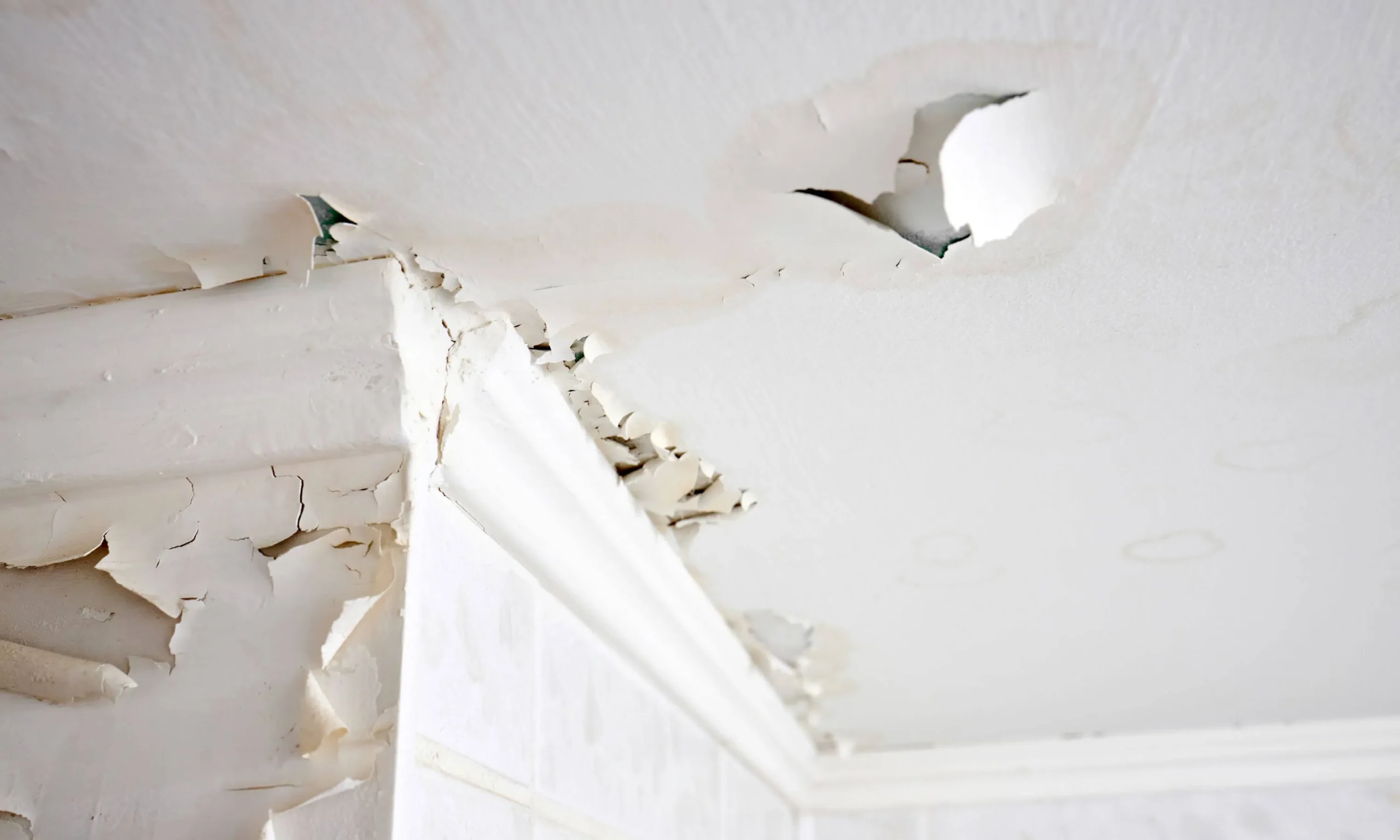 The dilapidated ceiling of a condominium unit suffering water damage.